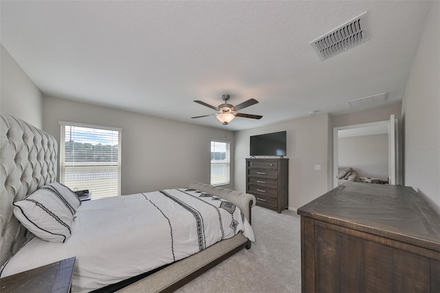 bedroom featuring ceiling fan and light carpet