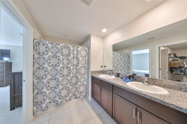 bathroom with double vanity and tile patterned flooring