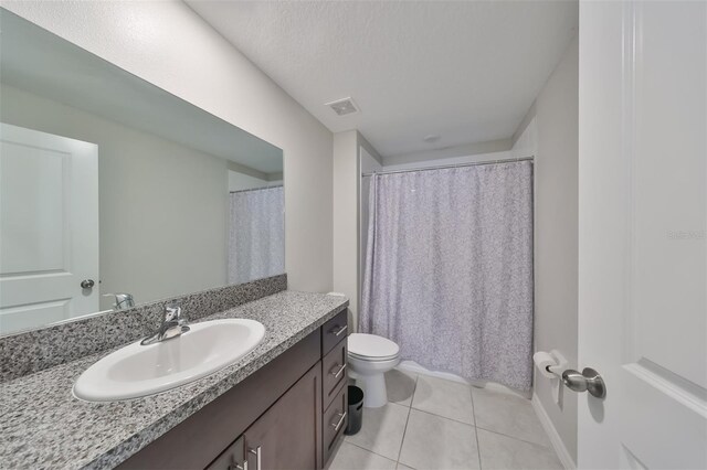 bathroom featuring toilet, tile patterned floors, and vanity