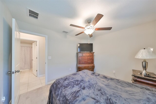 bedroom featuring light carpet and ceiling fan