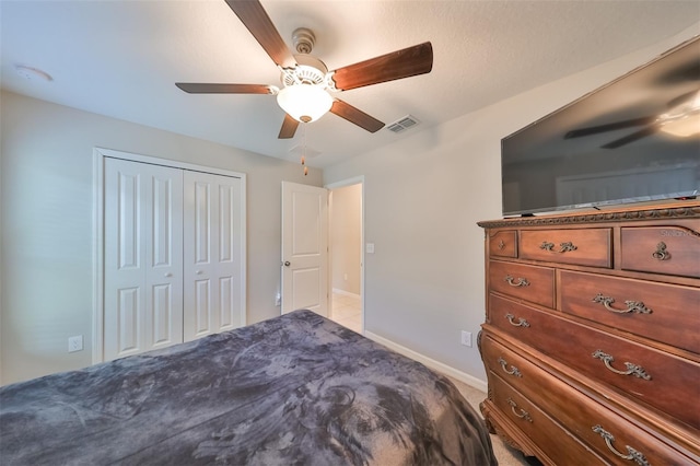 bedroom featuring ceiling fan and a closet