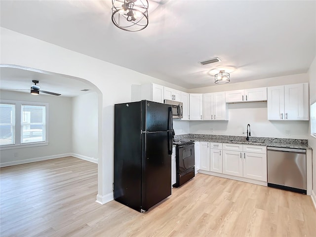 kitchen with black appliances, white cabinets, light wood-type flooring, and sink