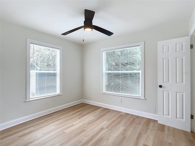 spare room with ceiling fan and light wood-type flooring