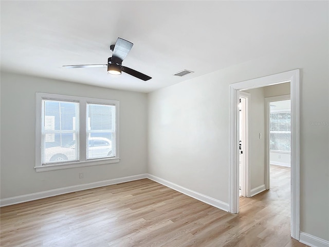 unfurnished room with ceiling fan, plenty of natural light, and light hardwood / wood-style flooring