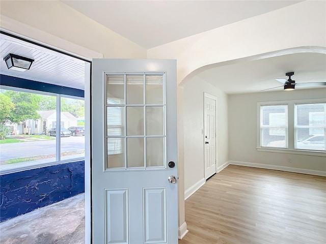 doorway to outside with ceiling fan and light hardwood / wood-style flooring