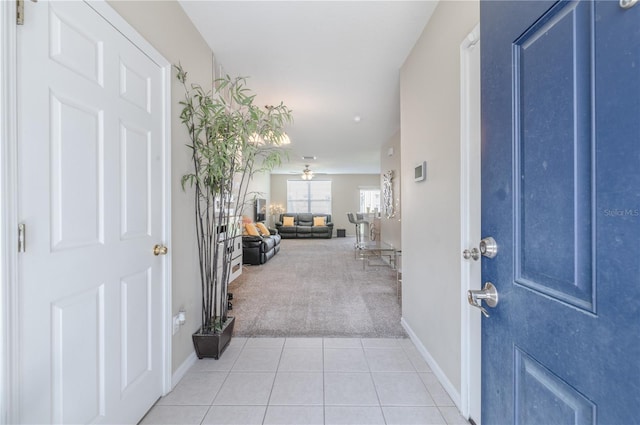 carpeted foyer entrance with ceiling fan