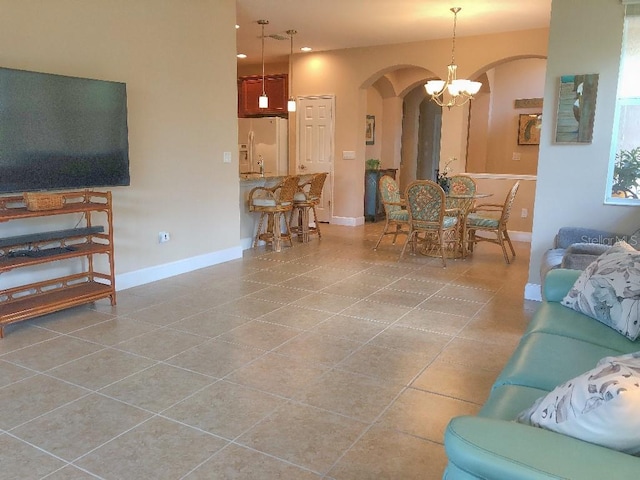 living room with an inviting chandelier and tile patterned flooring