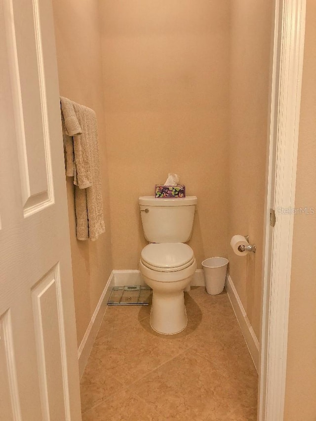 bathroom featuring tile patterned flooring and toilet