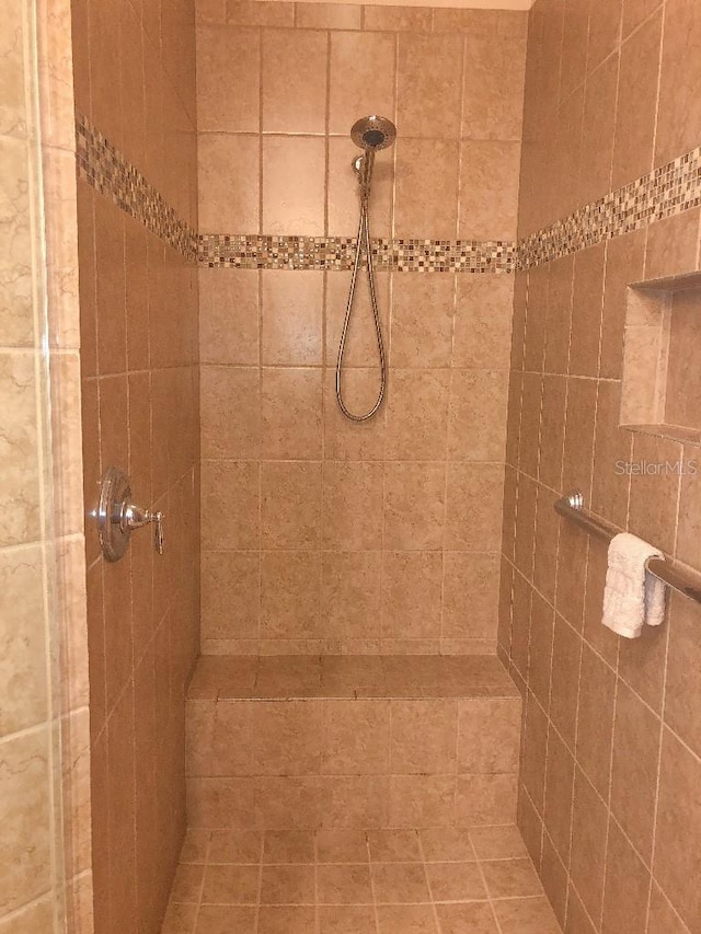 bathroom with a tile shower