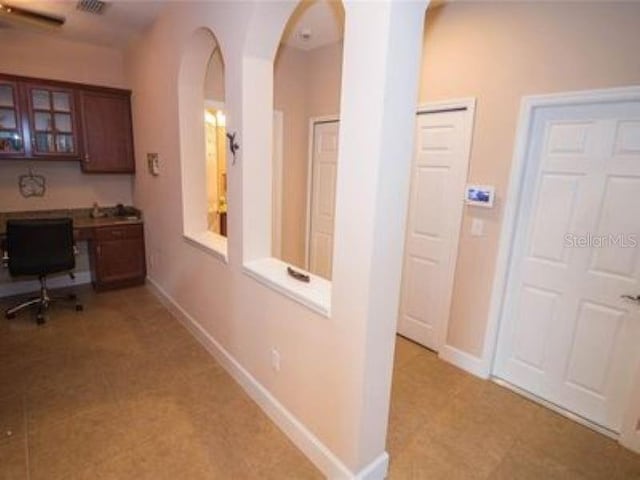 809 Chipper Dr, Sun City Center, FL 33573 - hallway with baseboards and arched walkways