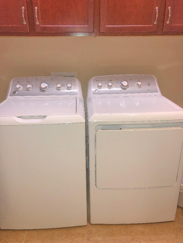 809 Chipper Dr, Sun City Center, FL 33573 - laundry room with cabinet space, independent washer and dryer, and light tile patterned floors