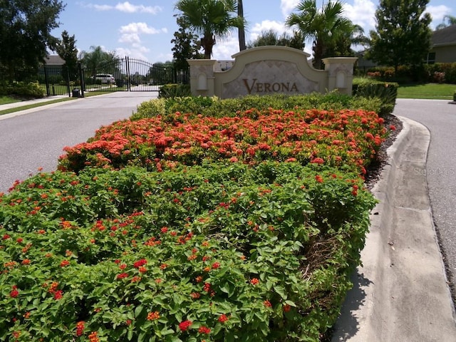 809 Chipper Dr, Sun City Center, FL 33573 - community / neighborhood sign featuring a gate and fence