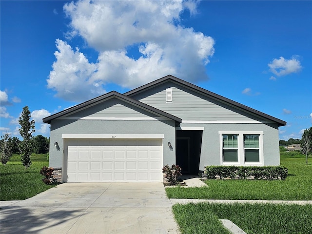 single story home featuring a garage and a front lawn