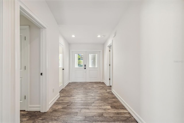 corridor with dark hardwood / wood-style flooring