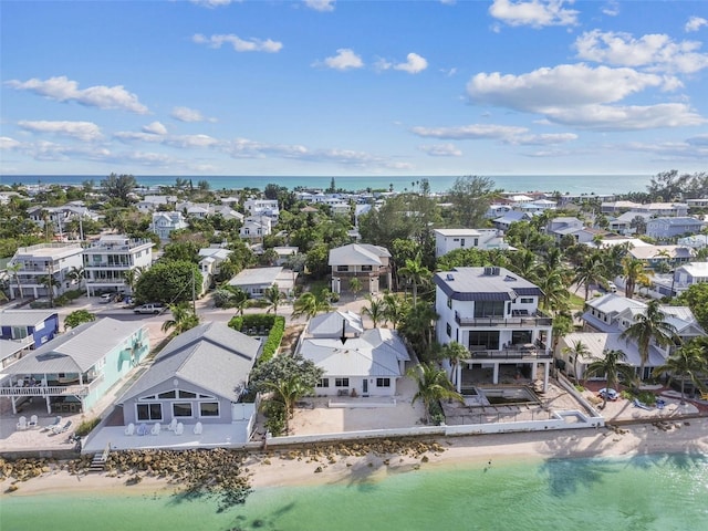 birds eye view of property featuring a beach view and a water view