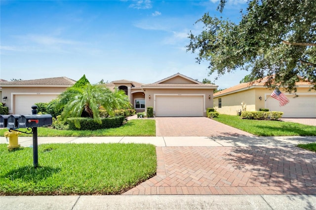 view of front of house with a garage and a front lawn