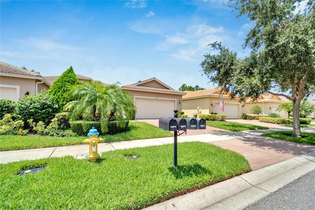 view of front of home featuring a front yard and a garage