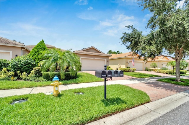 view of front of home with a front yard, decorative driveway, and stucco siding