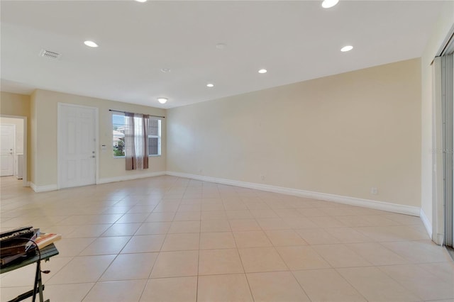 empty room with light tile patterned floors, recessed lighting, visible vents, and baseboards