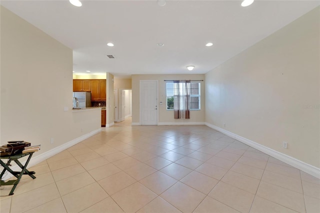 unfurnished living room with baseboards and recessed lighting