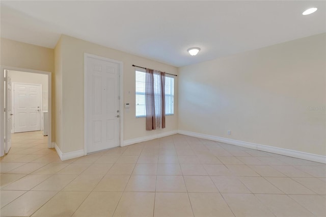 foyer entrance with recessed lighting, baseboards, and light tile patterned floors