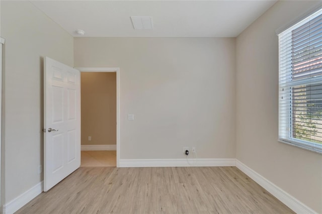 empty room with light wood-type flooring and baseboards