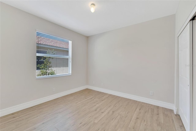 unfurnished bedroom featuring light wood-type flooring and a closet