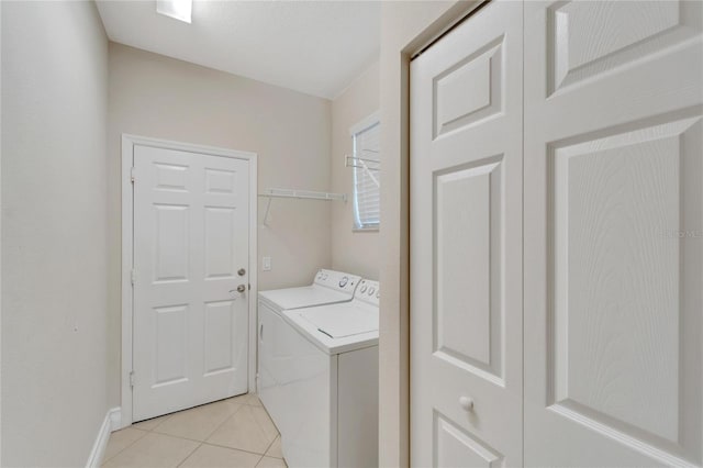 laundry room featuring independent washer and dryer and light tile patterned flooring