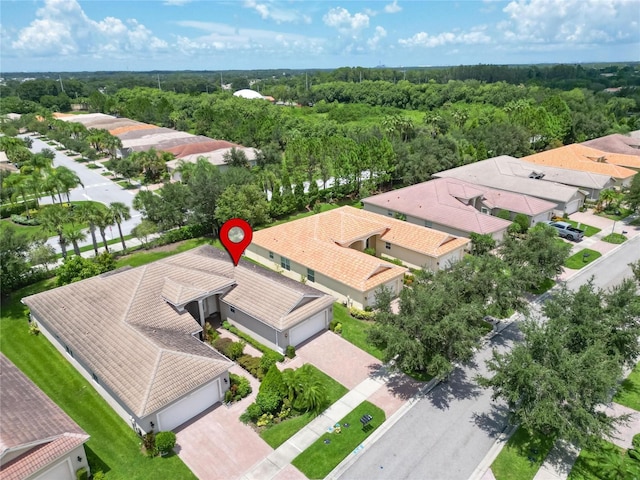 birds eye view of property with a residential view and a forest view