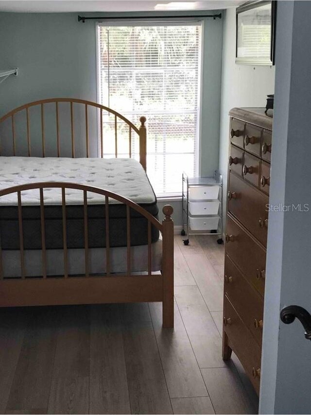 bedroom with hardwood / wood-style floors