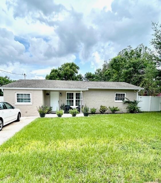 ranch-style home featuring a front yard