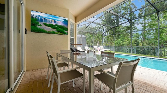 exterior space with a lanai and a fenced in pool