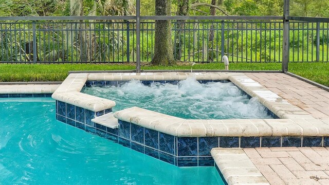 view of swimming pool featuring a jacuzzi and pool water feature