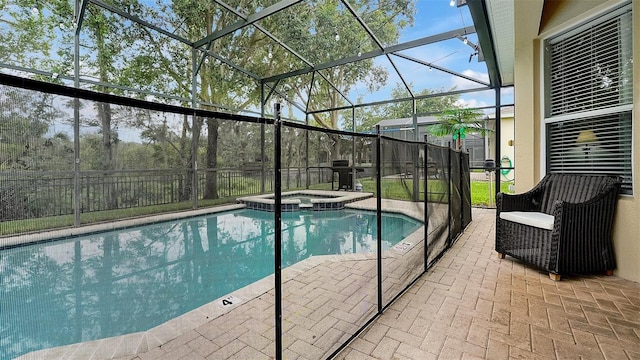 view of pool featuring a lanai, an in ground hot tub, and a patio