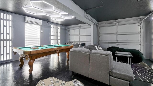 rec room featuring concrete floors, a textured ceiling, pool table, and a wall mounted air conditioner