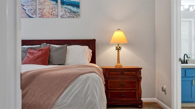 bedroom with carpet and sink