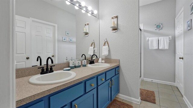 bathroom featuring double vanity and tile patterned flooring