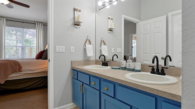 bathroom featuring ceiling fan and double vanity