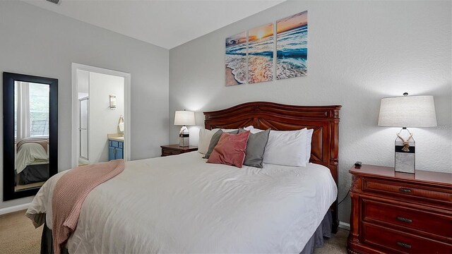 carpeted bedroom with connected bathroom