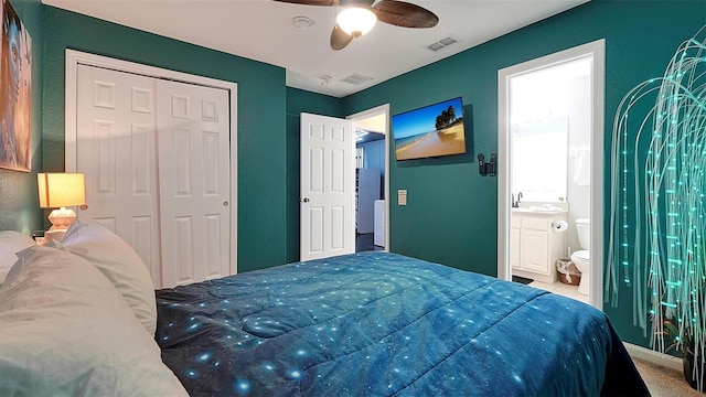 bedroom with ceiling fan, stainless steel fridge, ensuite bathroom, and a closet