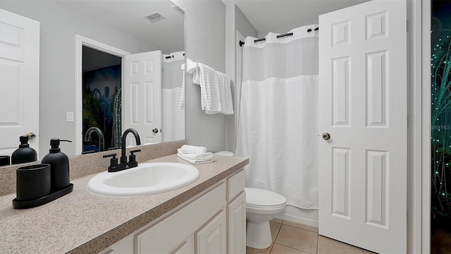 bathroom featuring tile patterned floors, vanity, and toilet