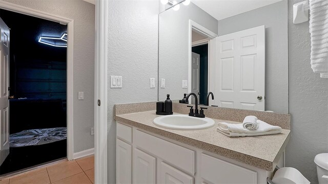 bathroom with tile patterned floors, vanity, and toilet