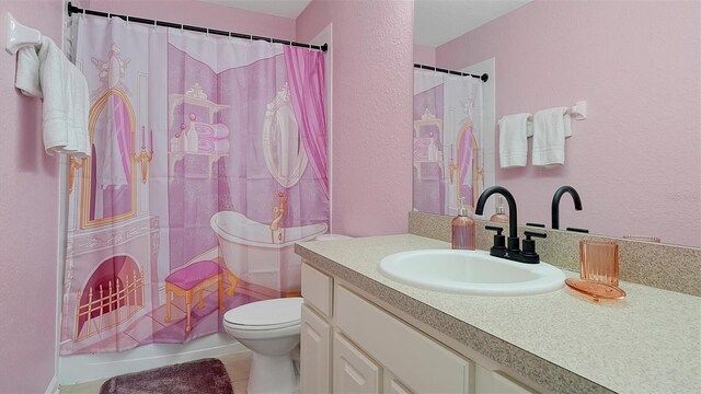 bathroom with vanity, toilet, and tile patterned flooring