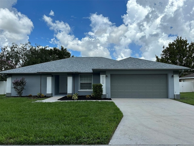 view of front facade with a front lawn and a garage