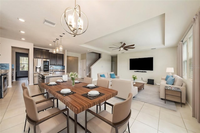 dining room with light tile patterned floors, visible vents, stairway, a tray ceiling, and recessed lighting