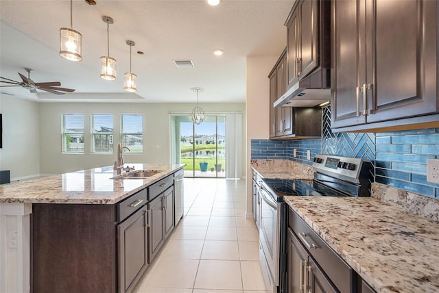 kitchen with stainless steel appliances, a kitchen island with sink, a sink, and hanging light fixtures