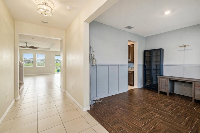 hallway featuring visible vents and baseboards