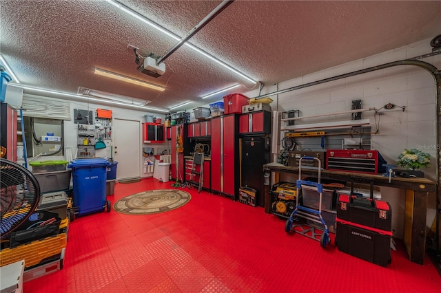 garage featuring a garage door opener and a workshop area