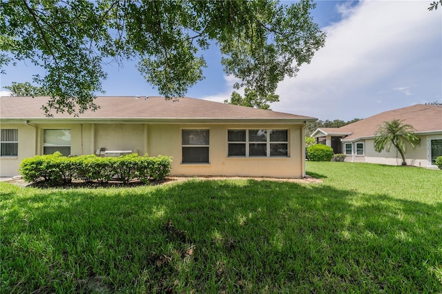 back of property featuring a yard