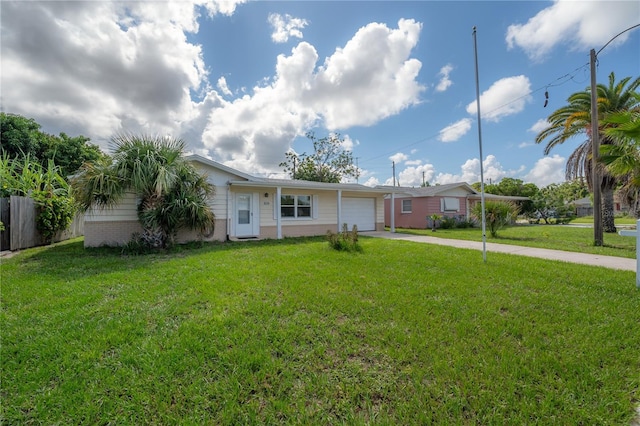 single story home with a garage and a front lawn